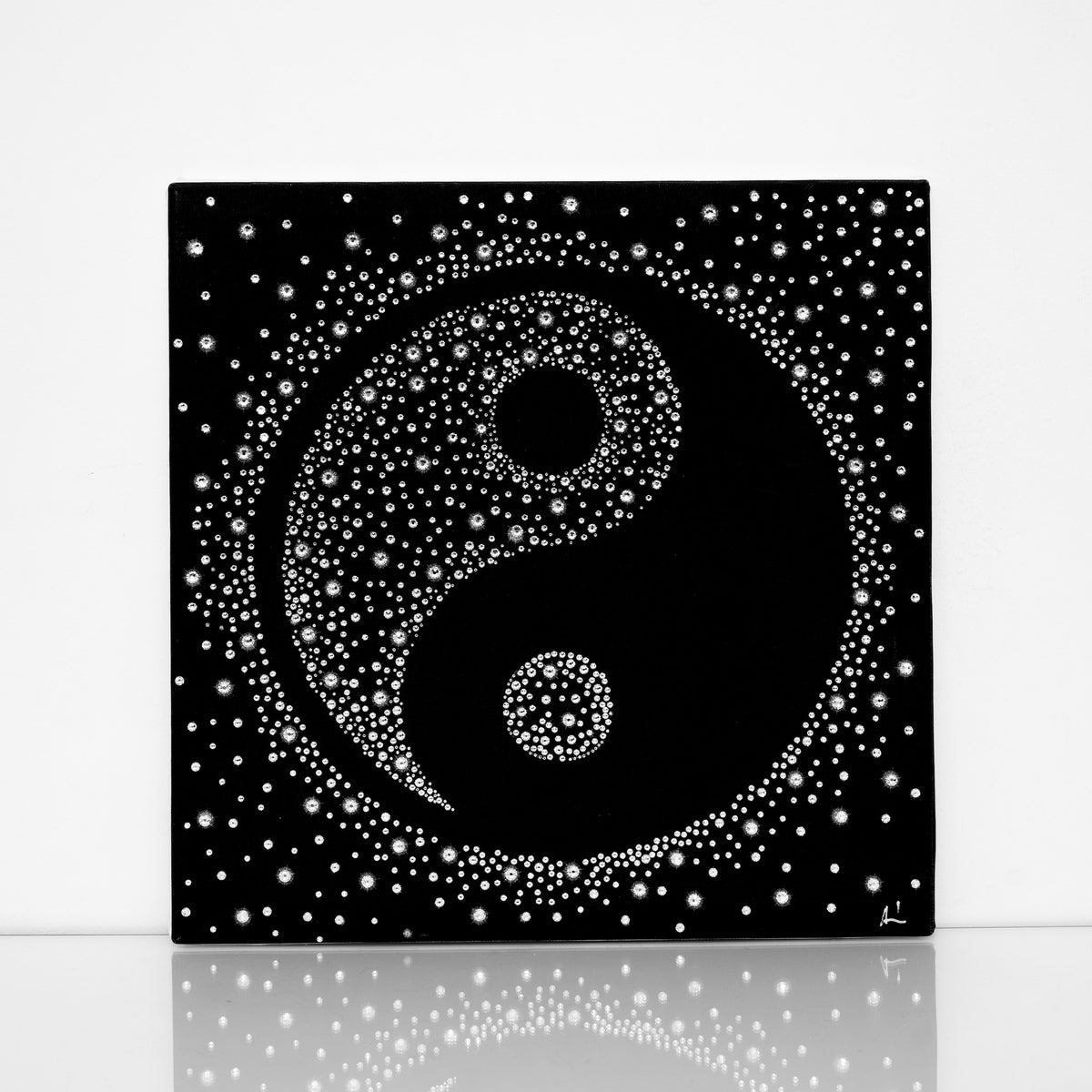 Black and white Yin-Yang canvas print with clear crystals on shiny floor
