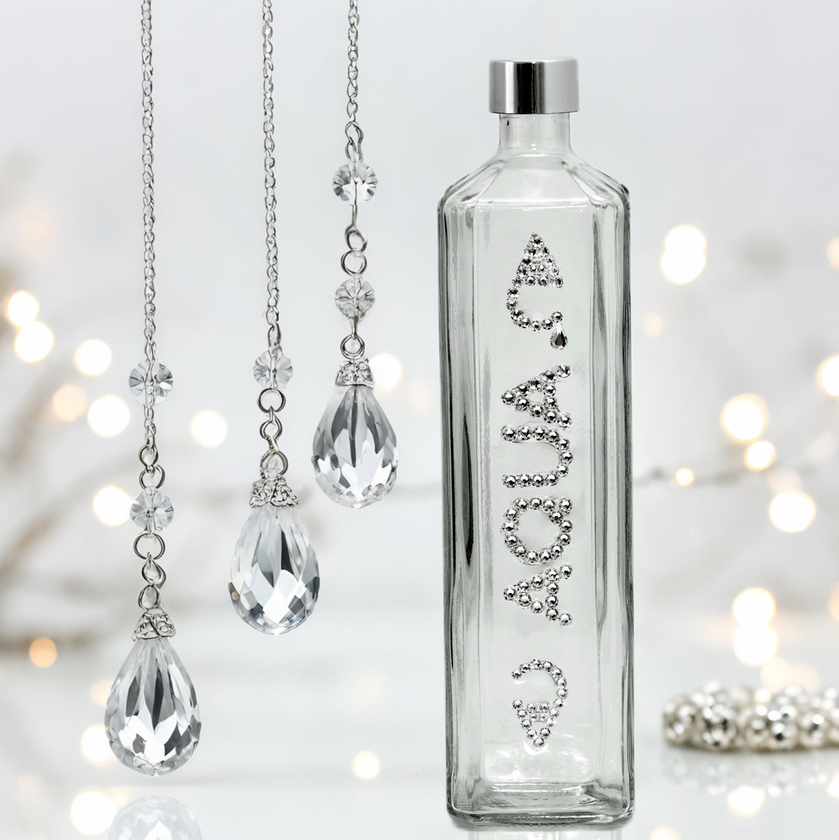 Aqua Carpatica square glass water bottle with clear crystals lettering and silver cap in clear jeweled glam setting