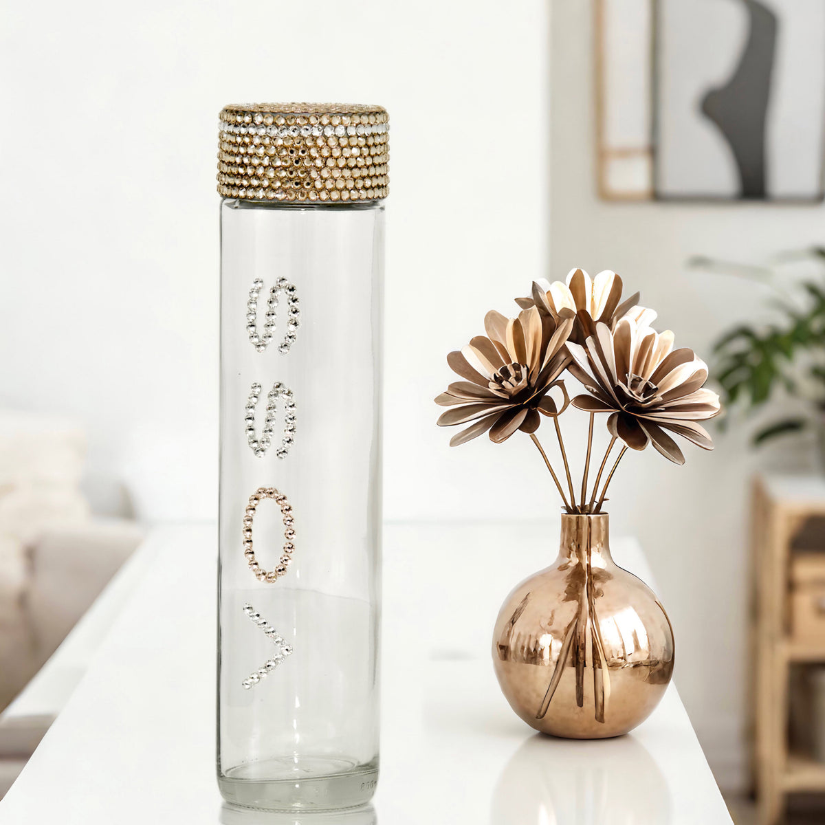 Voss glass water bottle with clear and champagne gold crystals in champagne gold floral glam setting