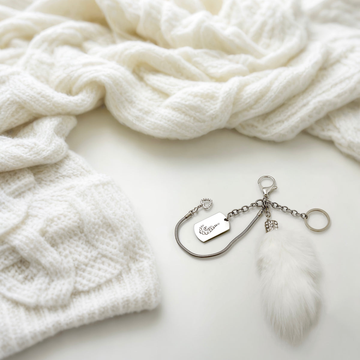 Silver Drop keychain with clear crystals and white angora fur tail charm in fashion setting