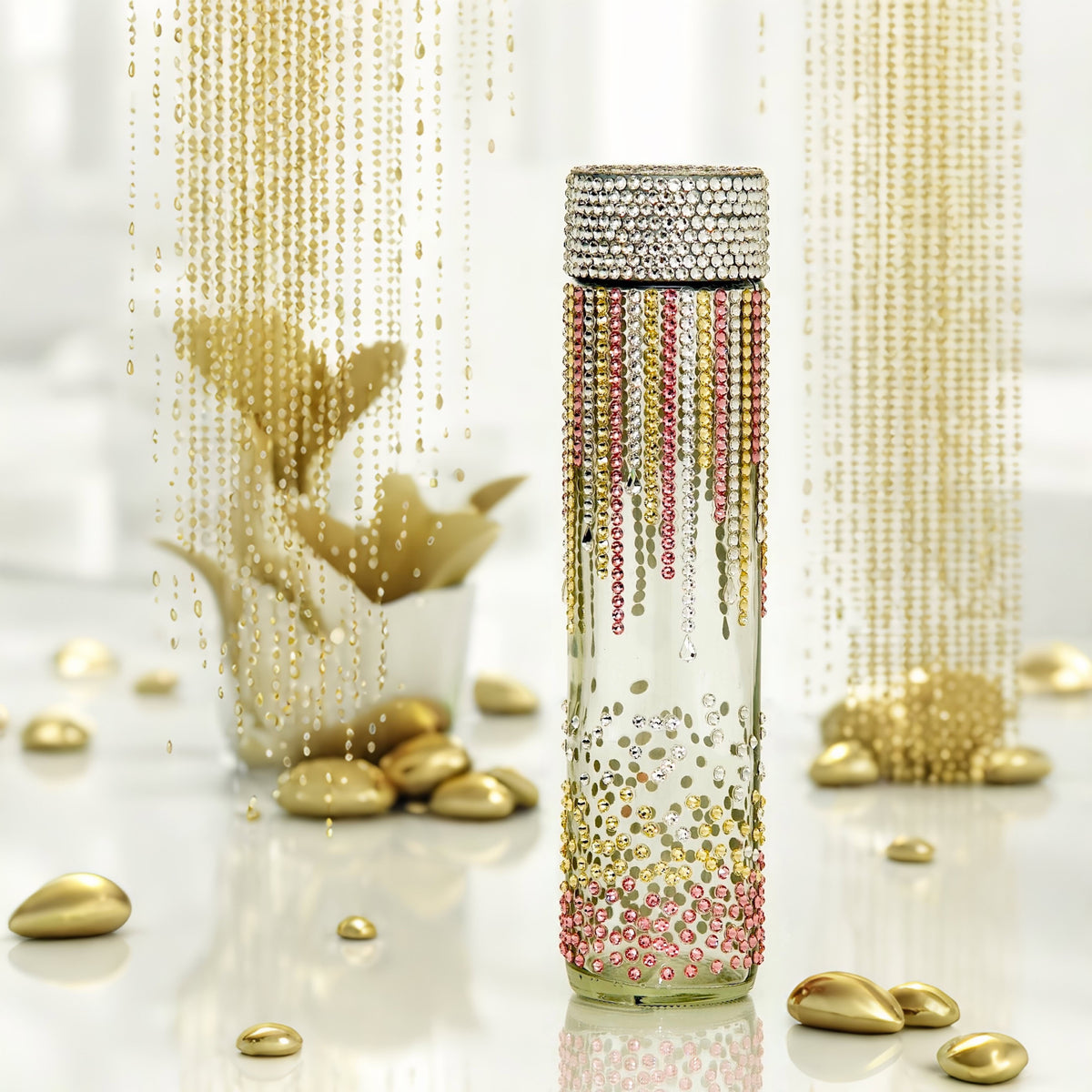 Colorful rain clear glass water bottle with falling and bouncing gold, pink and silver crystals in gold glam setting 